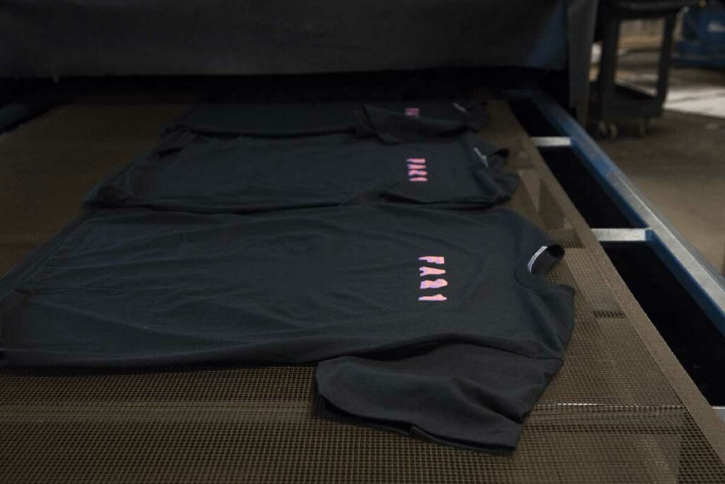 black t-shirt with pink font on it