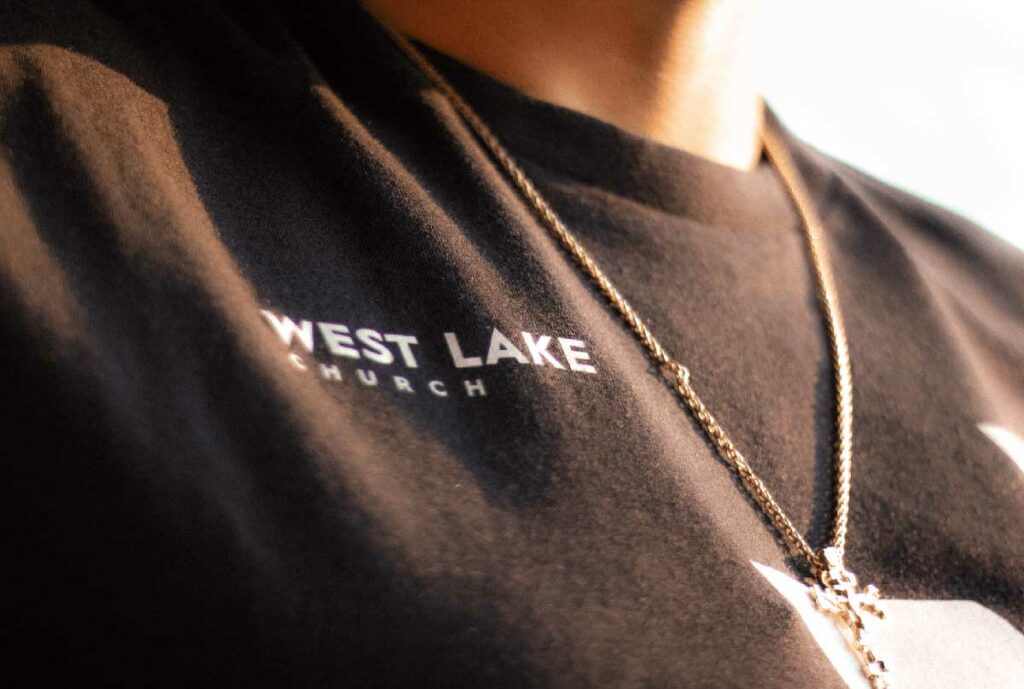 a black tshirt with the west lake church logo on it