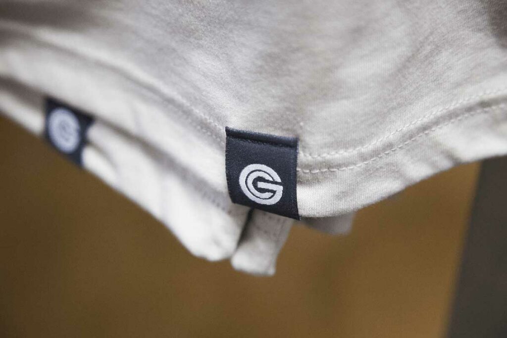 a hang tag on the sleeve of a tshirt