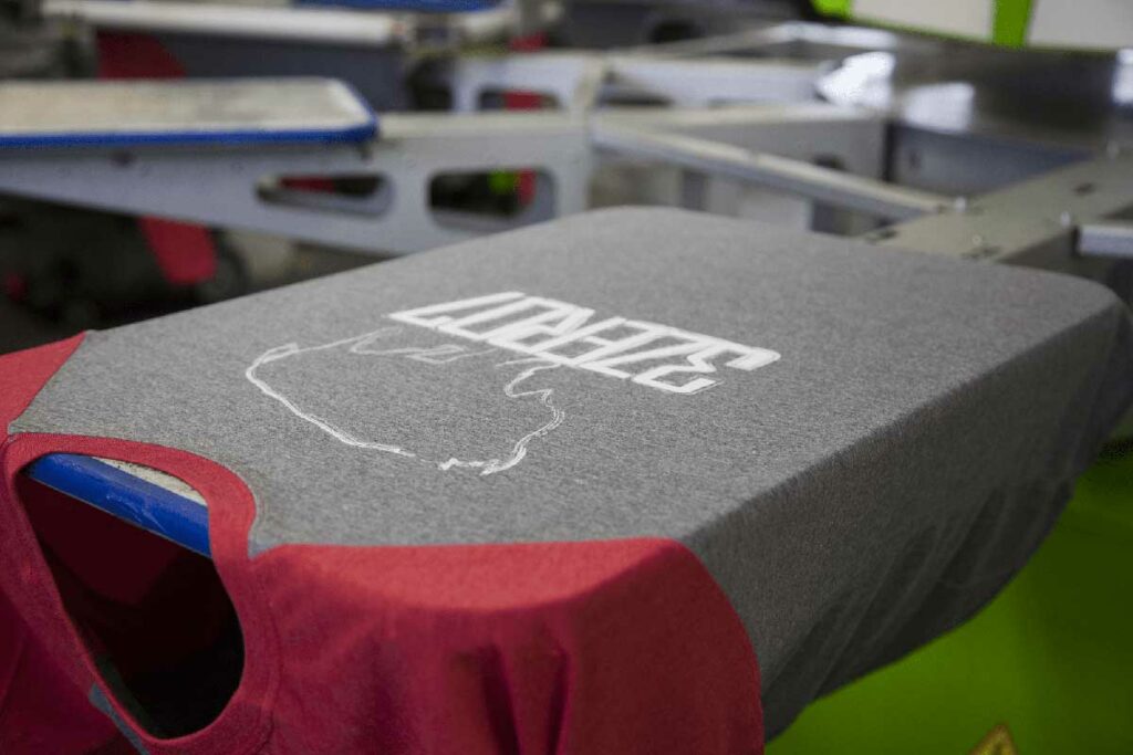 t-shirt with red sleeves on a screen printer