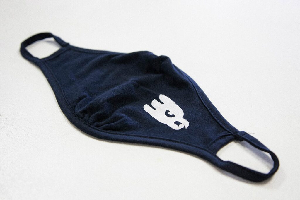 black cotton mask with logo on it
