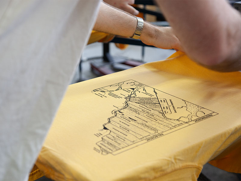 yellow t-shirt with a design on it